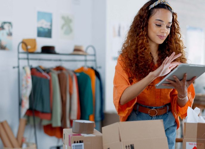 Tablet, logistics and fashion manager with a checklist in retail store clothes or clothing boxes inspection. Entrepreneur, shopping and small business owner writing stock delivery for quality control